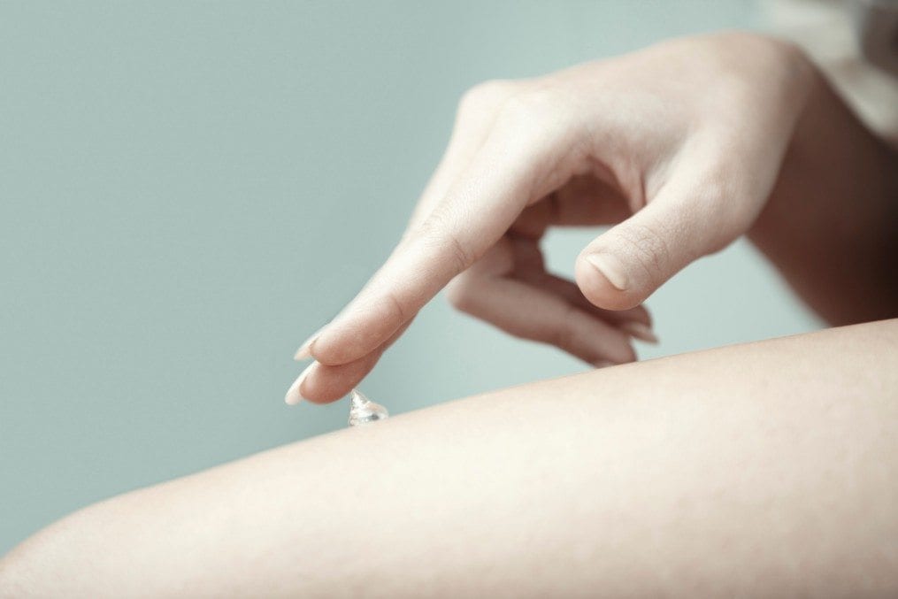 Woman applying eczema cream