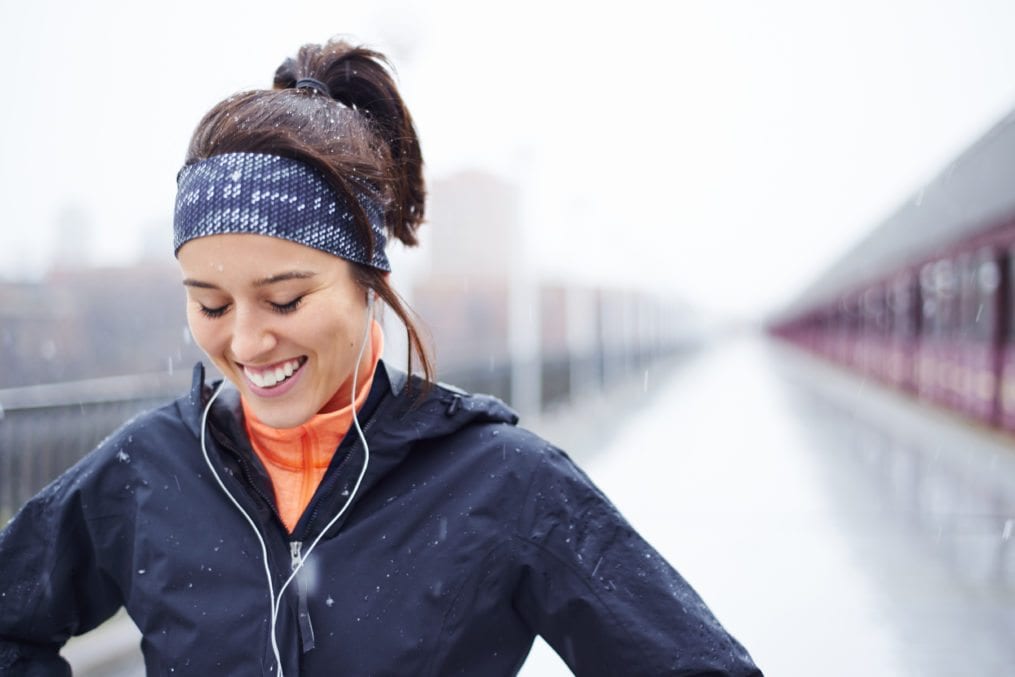 young woman exercising in the rain