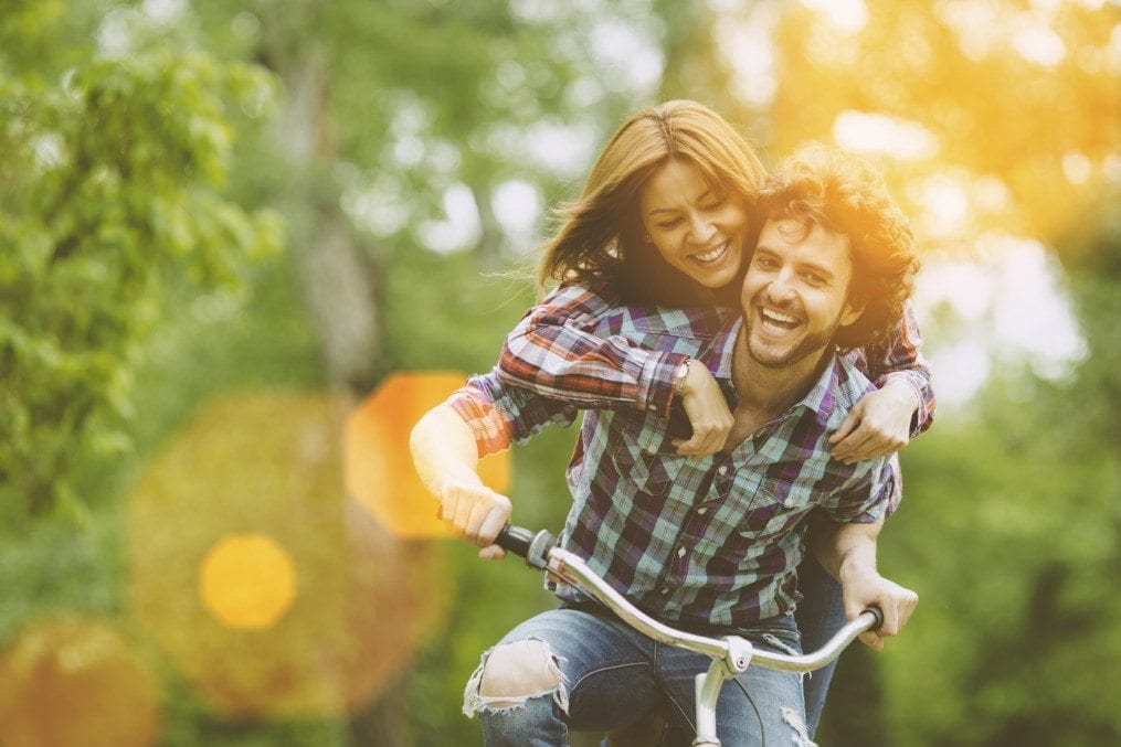 Happy couple riding a bicycle